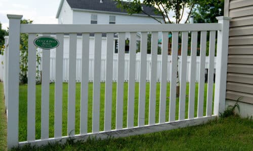 Slotted white vinyl fence