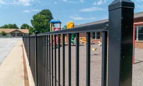 Close image of an aluminum fence around playground